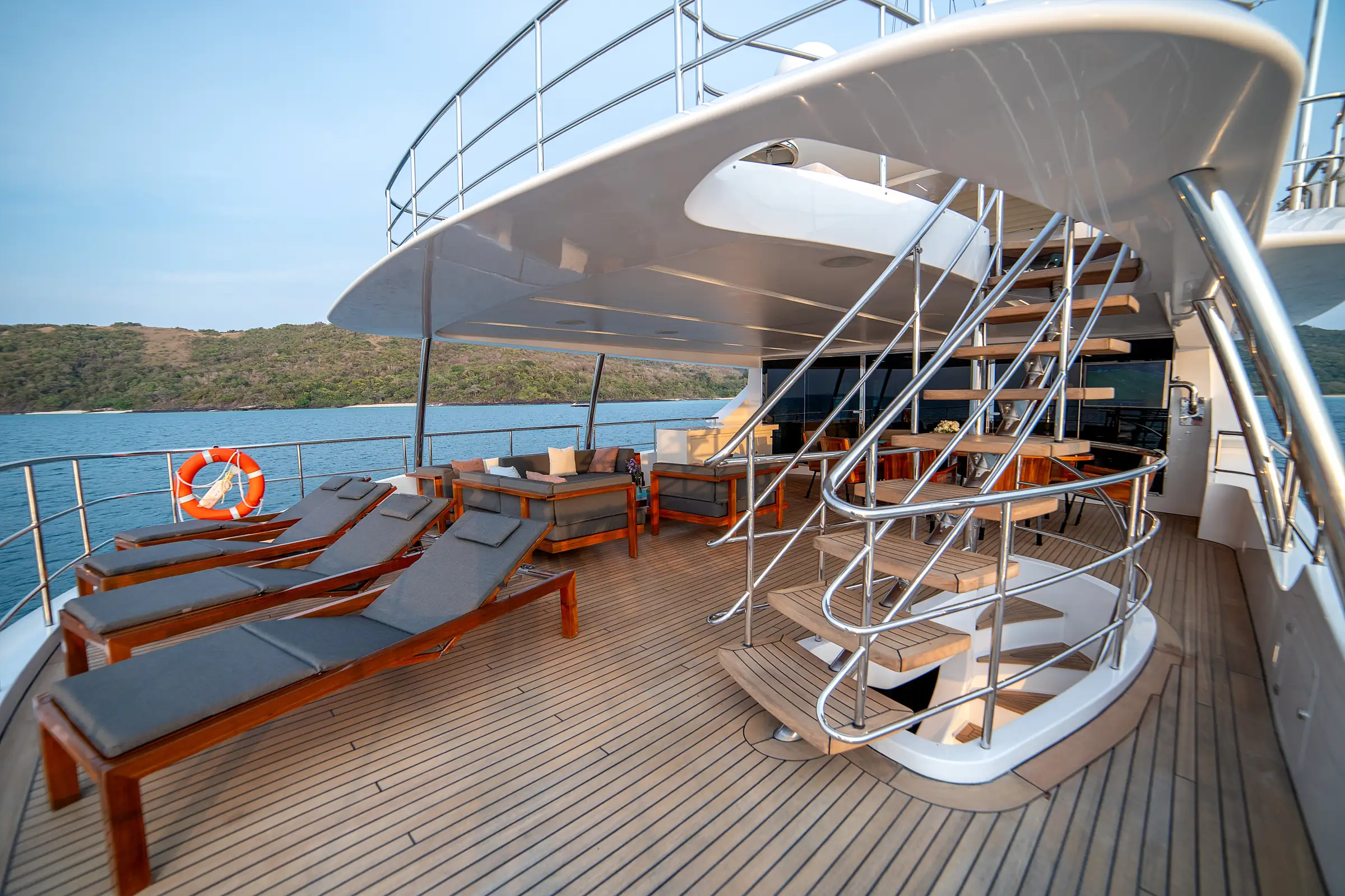 Loungers and the spiral stair on the aft upper deck