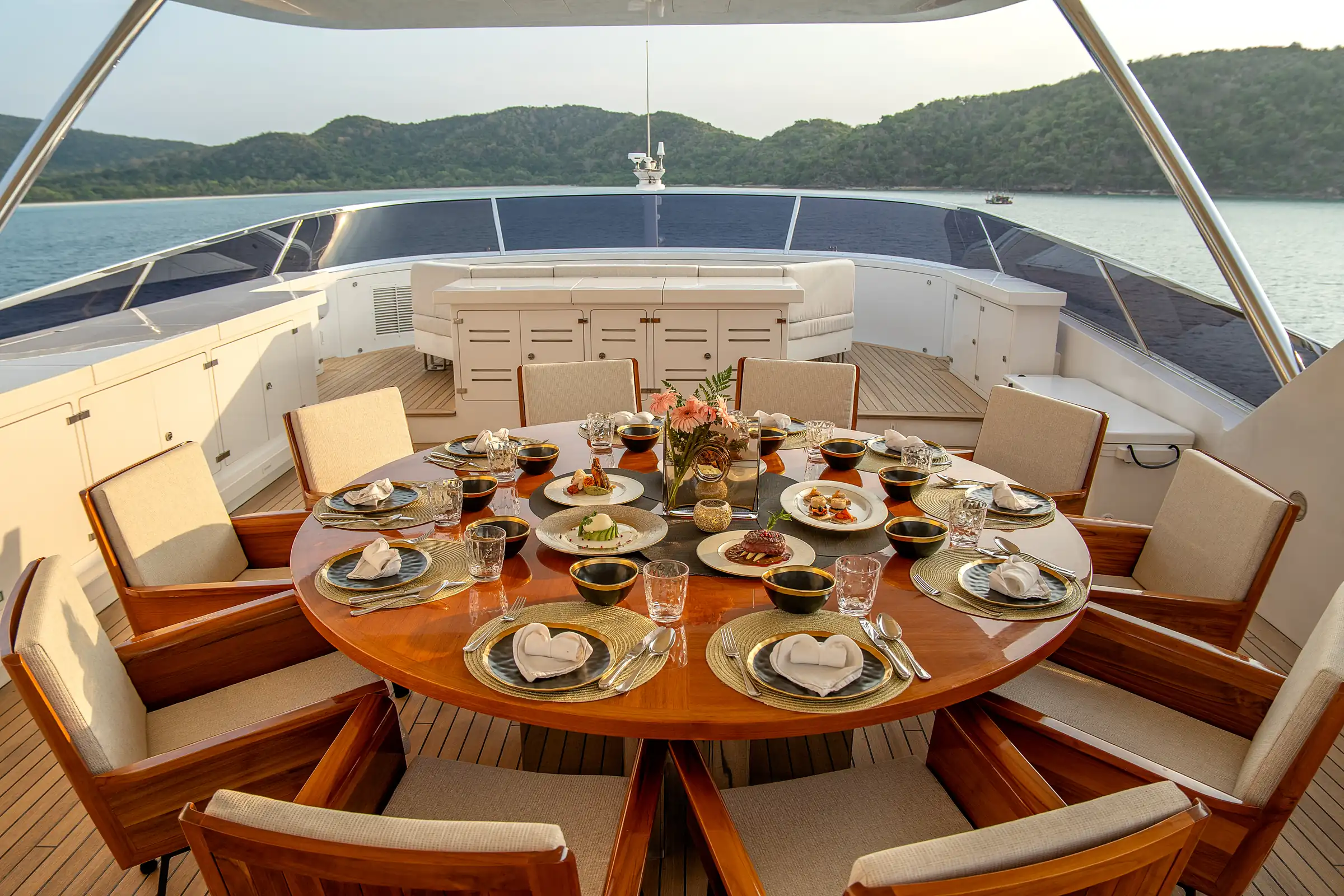 The round table laid for dinner on the sun deck