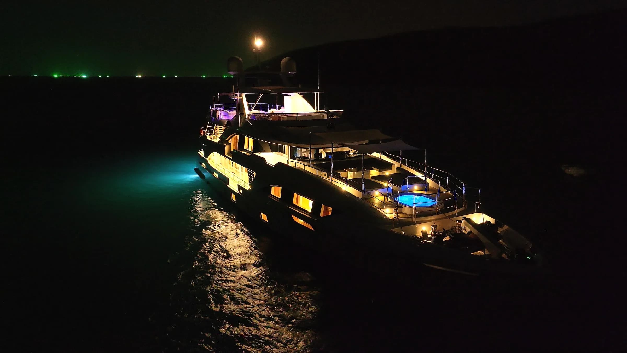 Asia Poseidon lit up after dark, her decks glowing