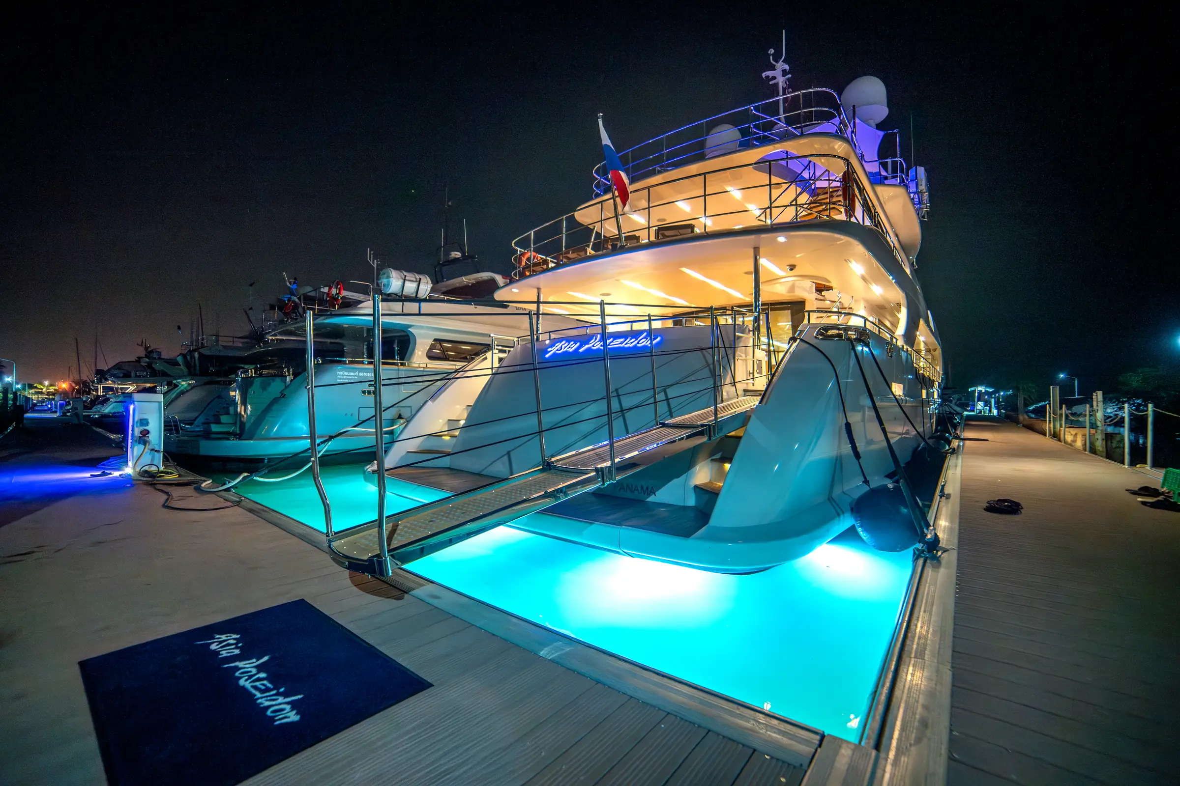 The swimming pool and slide off the swim platform, lit after dark