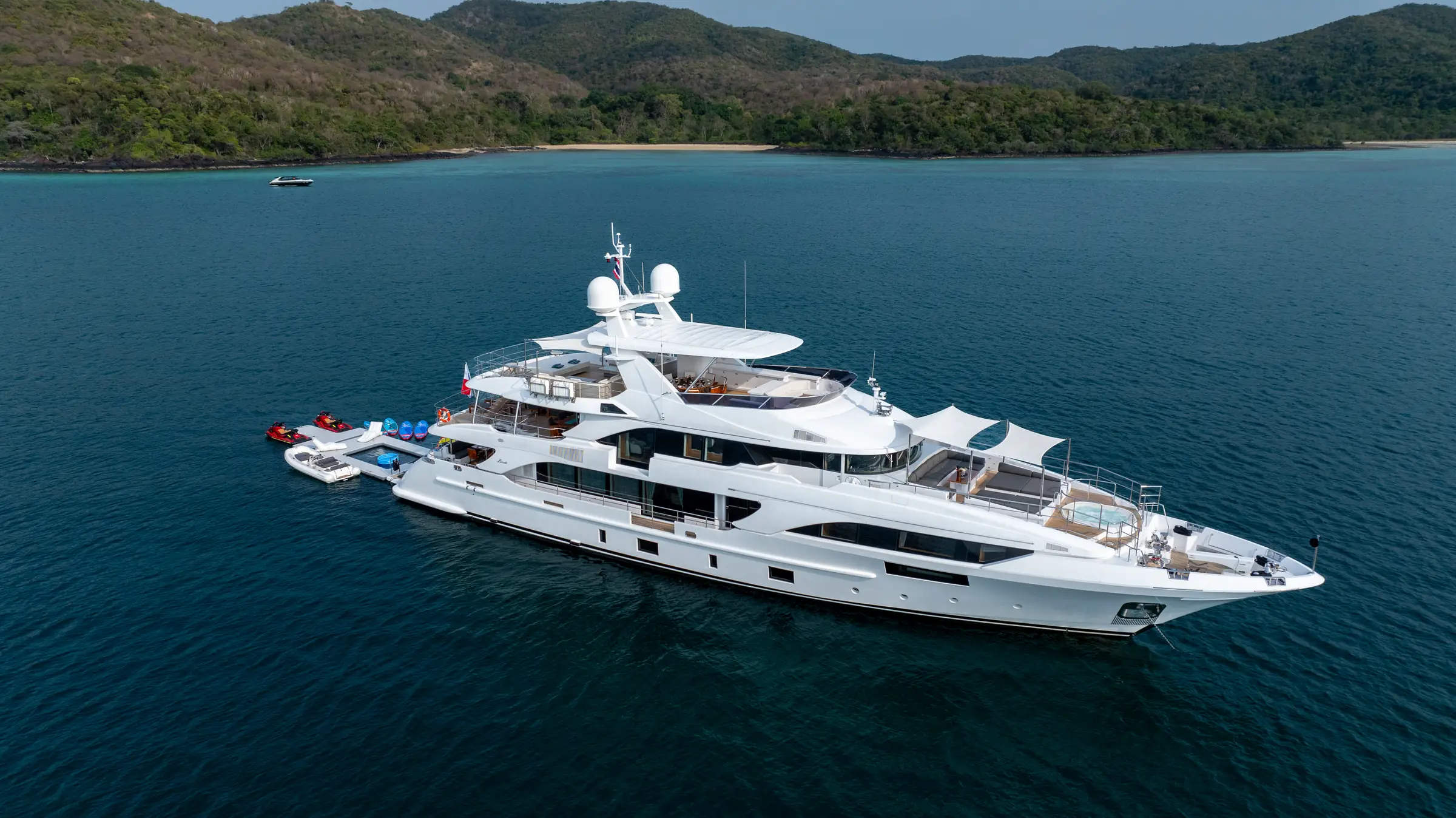 Asia Poseidon at anchor off a Gulf of Thailand island, her water toys out