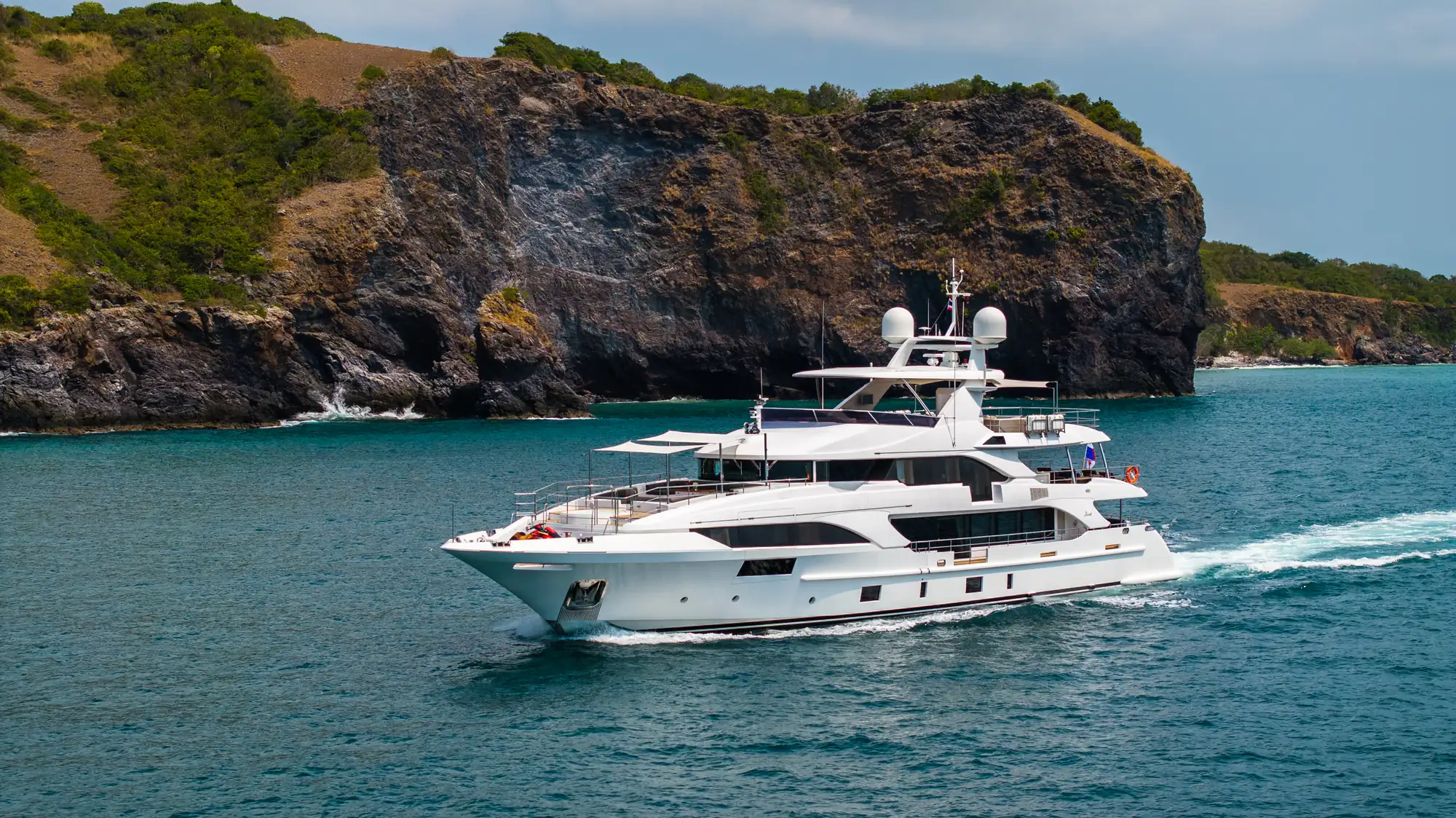 Asia Poseidon under way beneath a limestone cliff